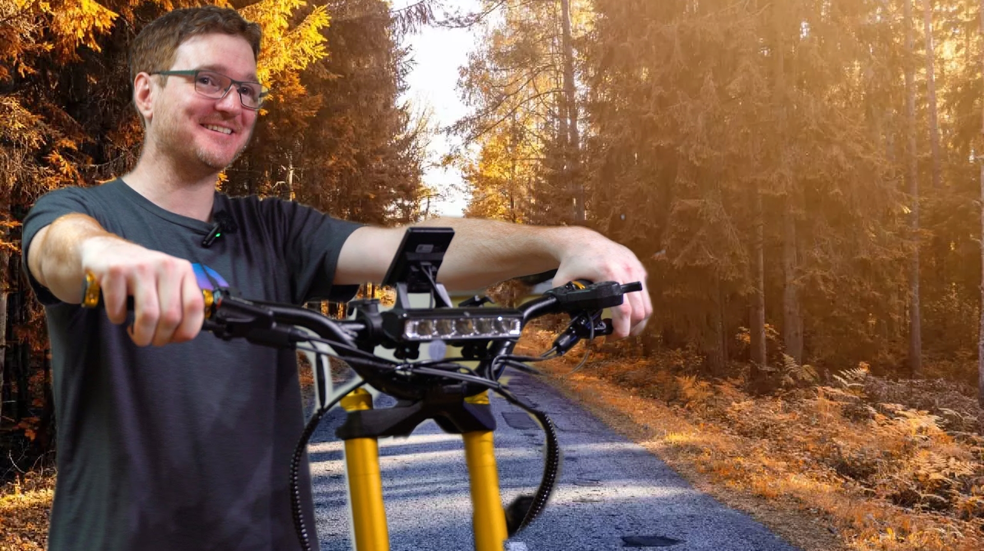man smiling holding an electric scooter